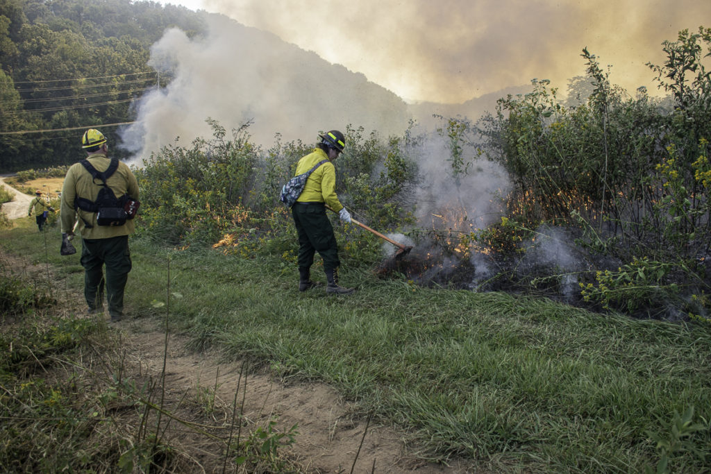Students assist with a prescribed burn at Seven Islands State Birding Park.