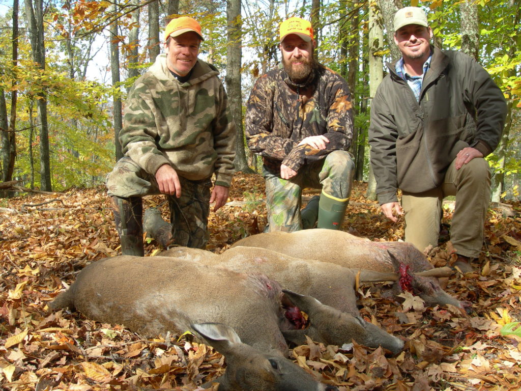 Craig Harper and two hunters with a harvested deer.